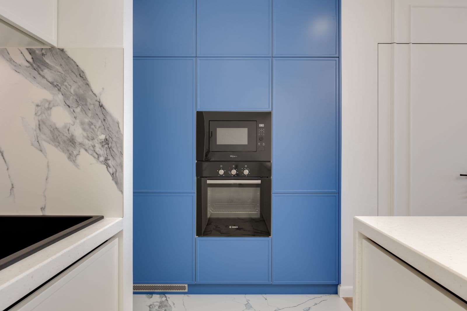 Microwave repair near you: built-in microwave above an oven in blue kitchen cabinetry