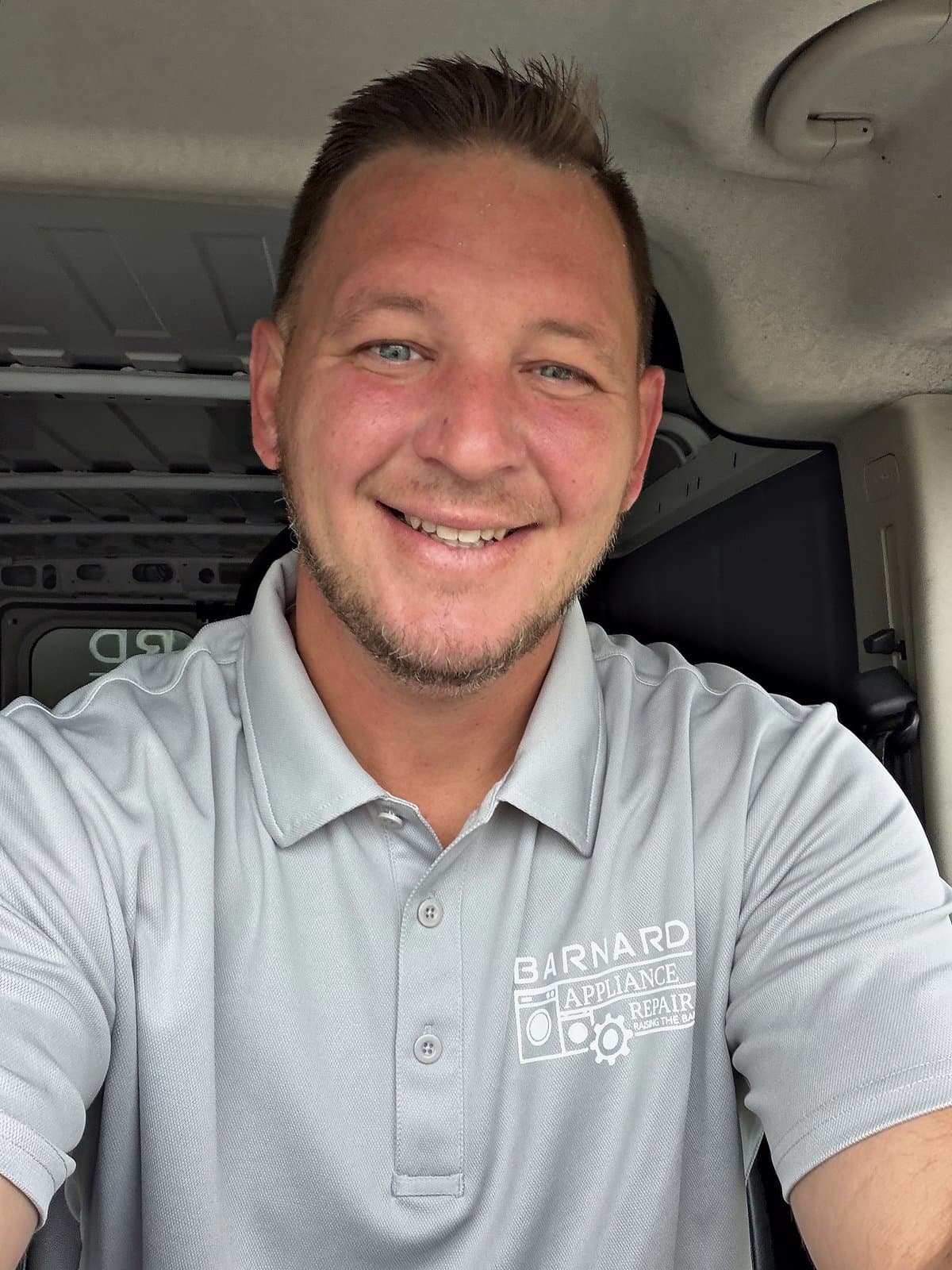 Ted Barnard in a company polo in his service van